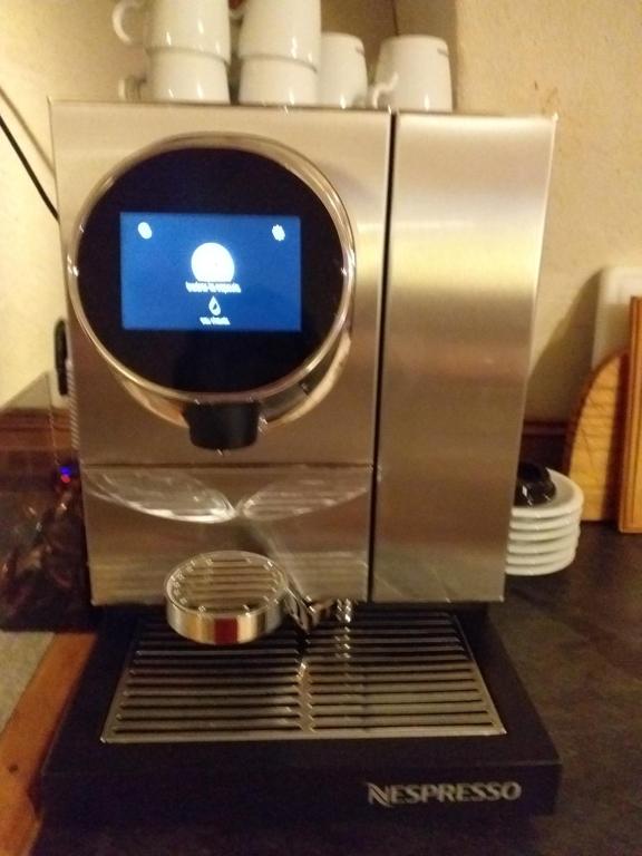 a coffee machine with a coffee pot on top of it at Le Bacchu Ber in Briançon