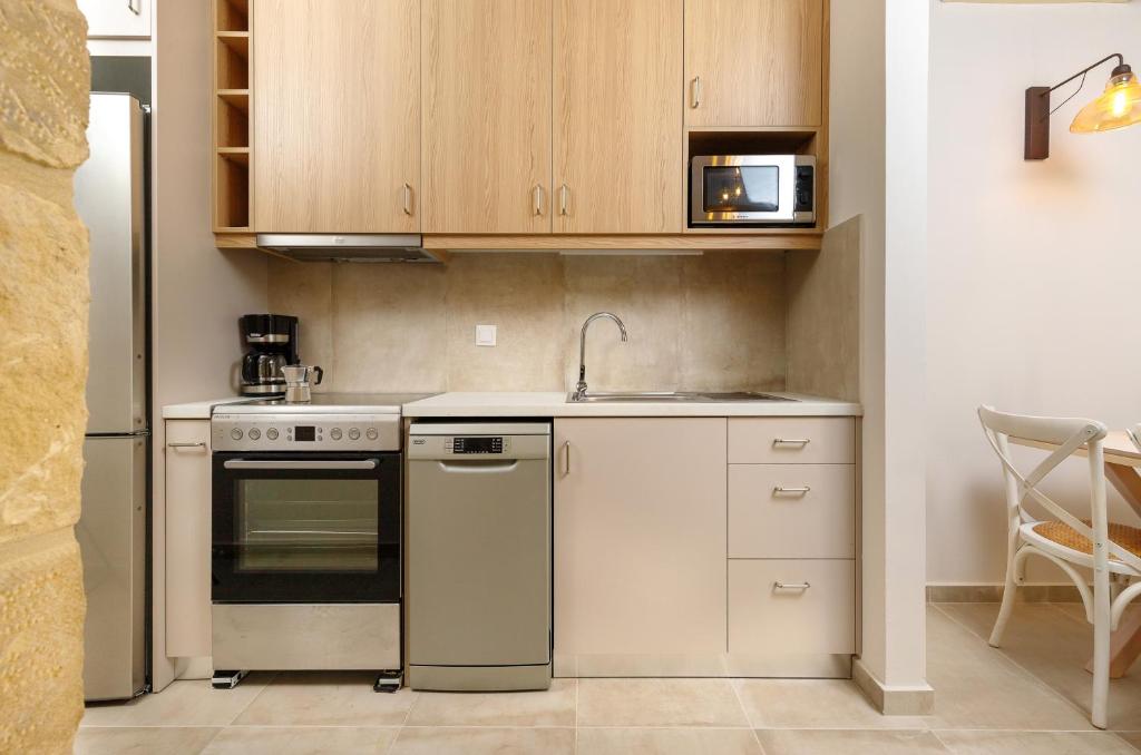 a small kitchen with a stove and a sink at Zefyros Apartments and House in Kissamos