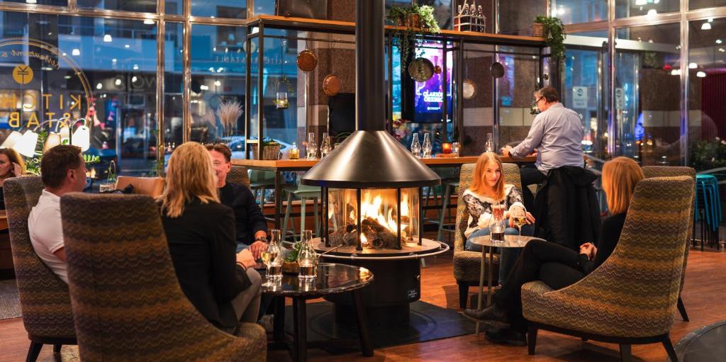 a group of people sitting at a table in a restaurant at Clarion Hotel Örebro in Örebro