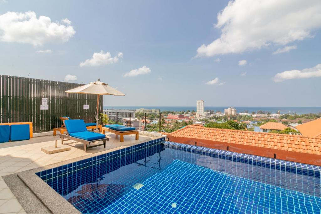 a swimming pool on the roof of a building at Orchidacea Residence in Karon Beach