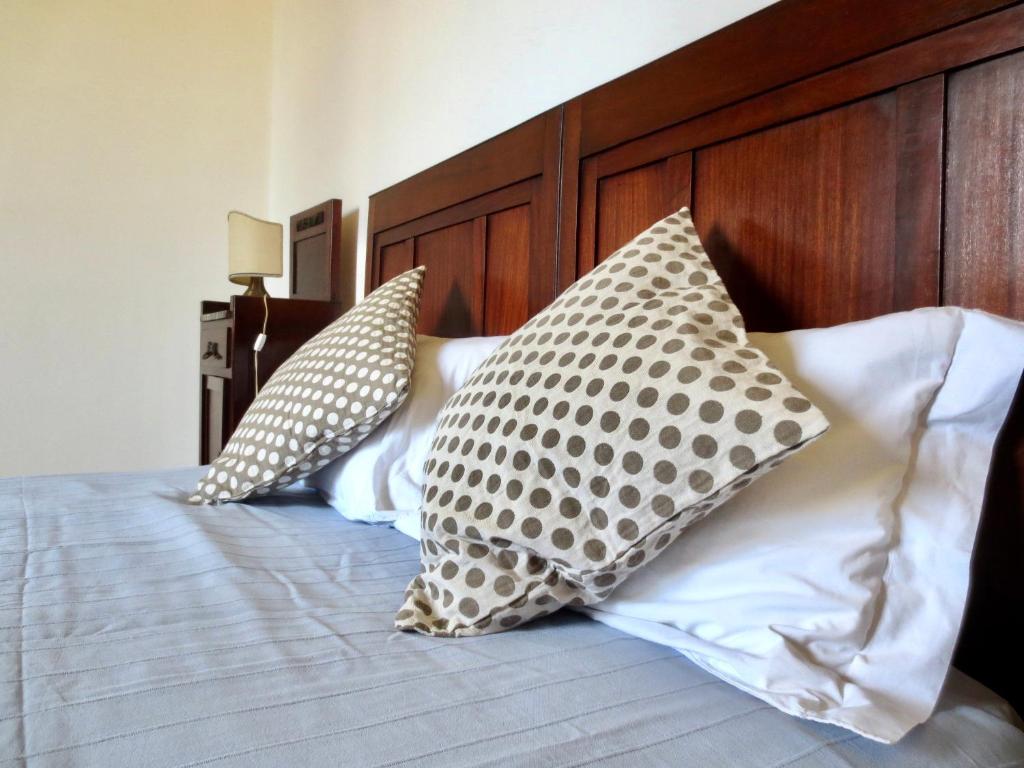 two pillows sitting on top of a bed at Villa Anna in Torre del Lago Puccini
