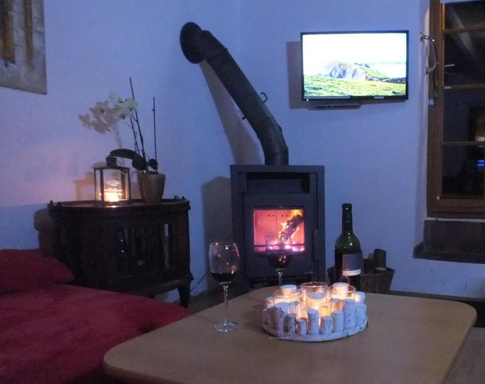 a living room with a table with candles and a fireplace at Ferienhaus "Spatzennest" Eifel Gerolstein Hunde ok in Oberbettingen