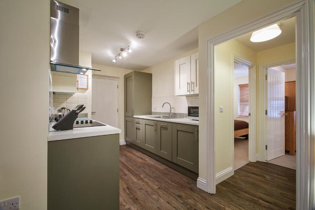 a kitchen with a sink and a counter top at Swan Place Apartments By Viridian Apartments in Swindon