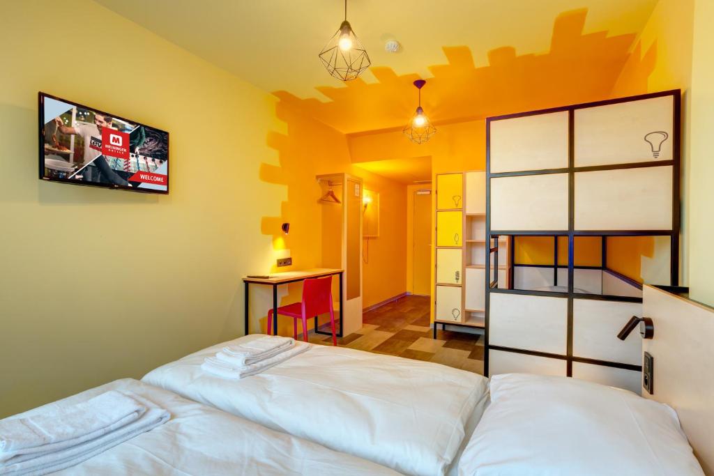 Postel nebo postele na pokoji v ubytování MEININGER Hotel Lyon Centre Berthelot