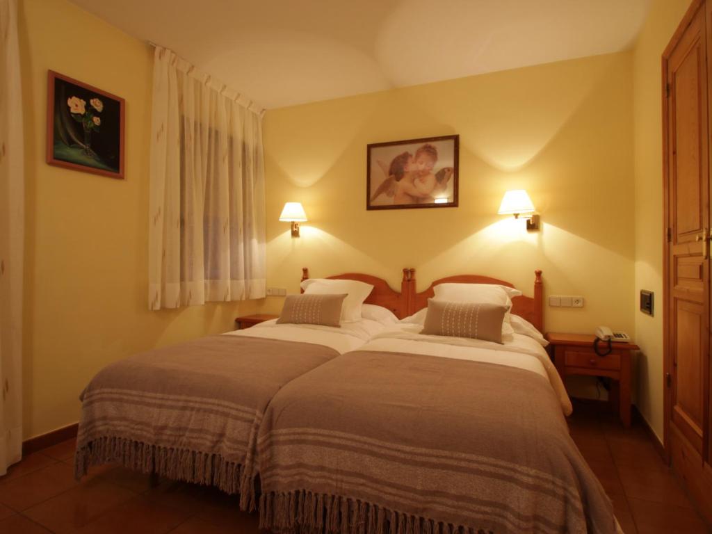 Postel nebo postele na pokoji v ubytování Hotel Ostau d'Òc