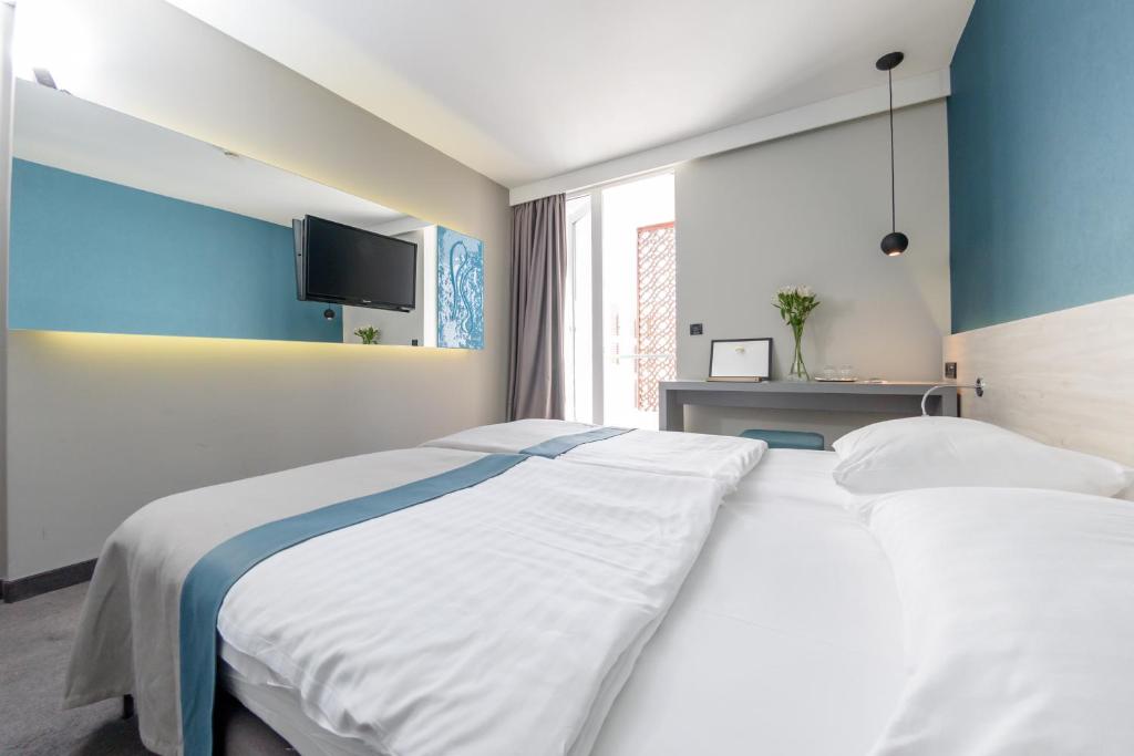Posteľ alebo postele v izbe v ubytovaní Hotel Kolovare