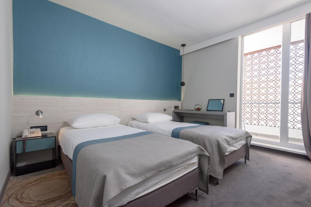 Posteľ alebo postele v izbe v ubytovaní Hotel Kolovare