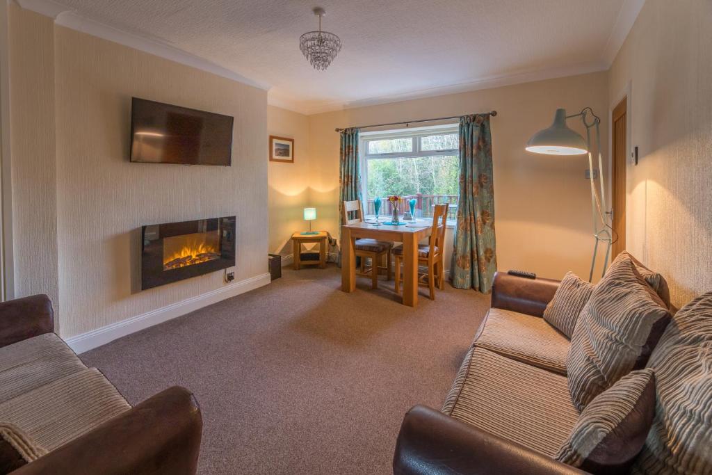 a living room with a couch and a fireplace at Host & Stay - Poppy Cottage in Bamburgh