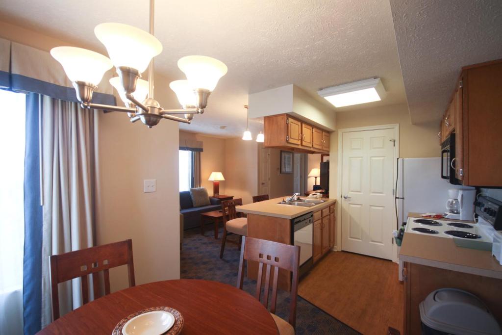 a kitchen and living room with a table and a dining room at Charwood Suites in Columbus