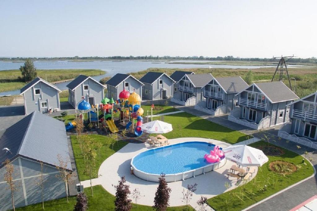 an aerial view of a resort with a pool and a playground at DOMY MARINA VILLAGE in Kąty Rybackie