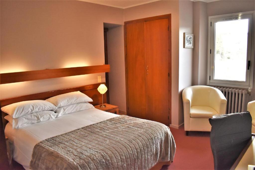Postel nebo postele na pokoji v ubytování Hotel Corrieu
