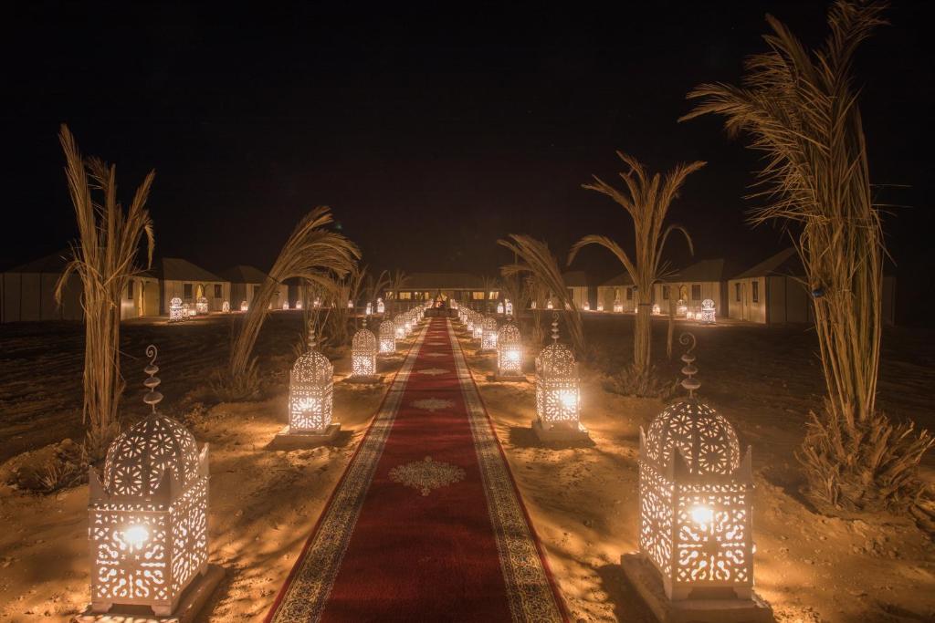 a row of lights in the desert at night at Luxury Desert Camp Amanar in Merzouga