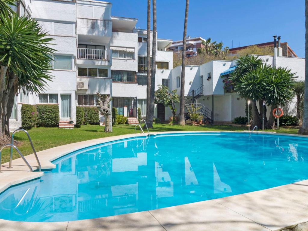 a swimming pool in front of a apartment building at Apartment Fontanilla by Interhome in Marbella