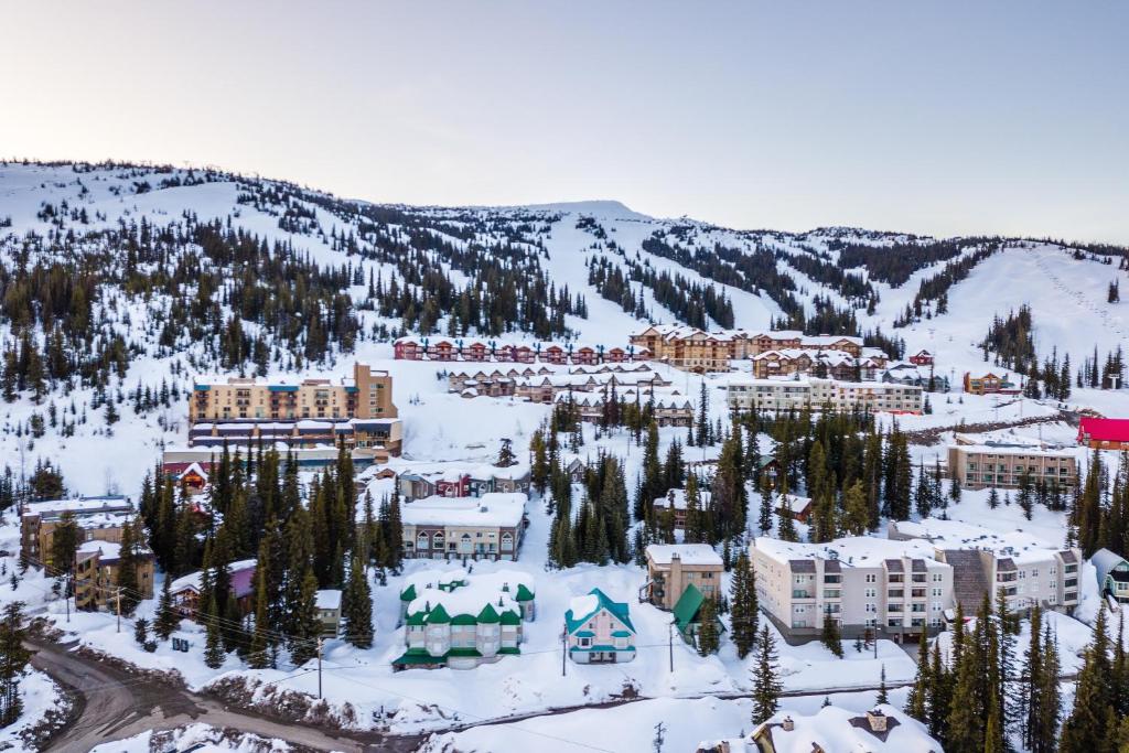 a resort in the middle of a snow covered mountain at Raven in Big White