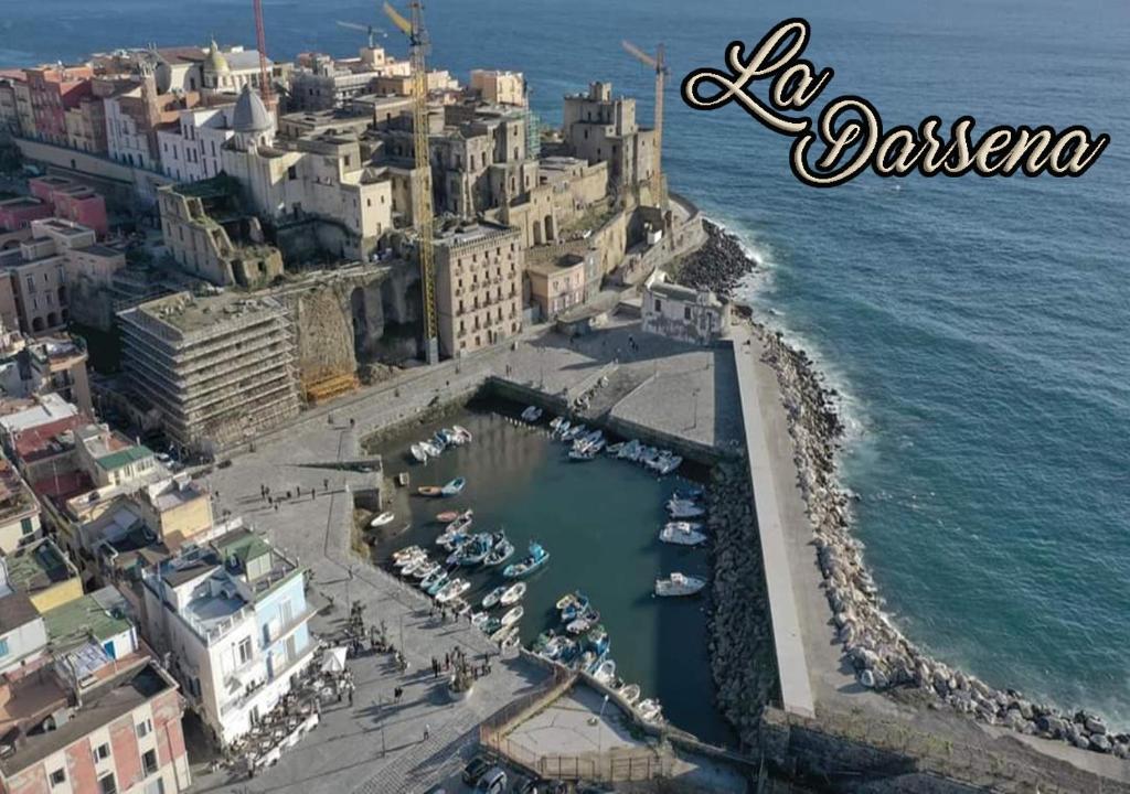 an aerial view of a city with boats in a harbor at Hotel Darsena in Pozzuoli