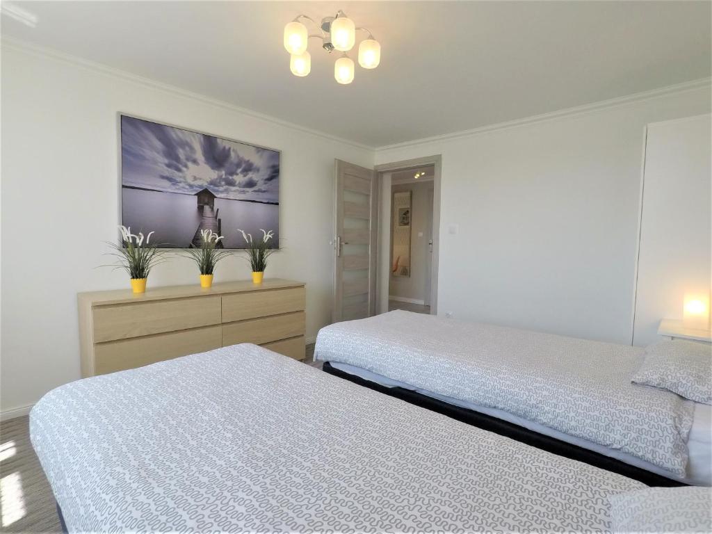 Posteľ alebo postele v izbe v ubytovaní Apartamenty Dobranoc - Wawer 2