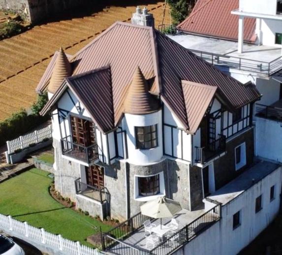 a large house with a roof on top of it at Villa de Roshe in Nuwara Eliya