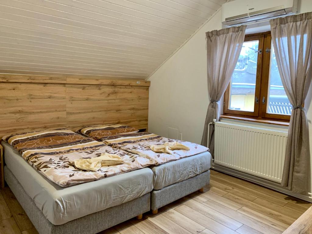 a bedroom with a large bed and a window at Ranč pod Babicou in Bojná