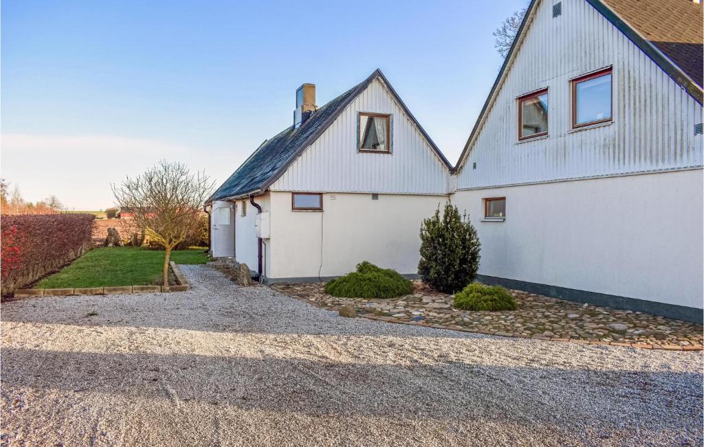 a white house with a gravel driveway at Lovely Apartment In Rydebck With Kitchen in Rydebäck