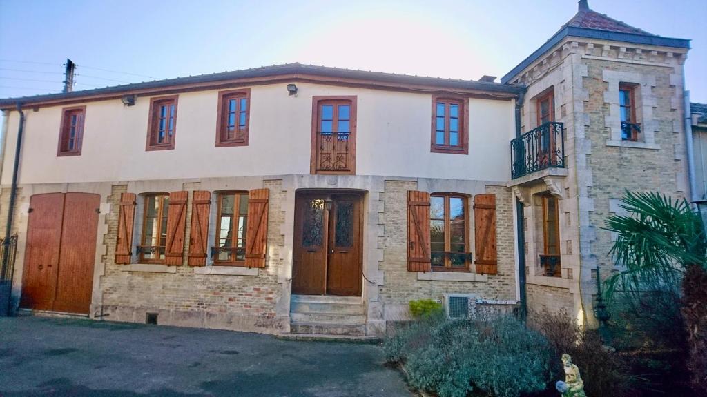 an old house with wooden doors and windows at La Champenoise in Marson