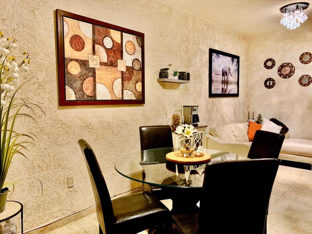 a living room with a table and chairs and a couch at Franks house "Shared House" in Cancún