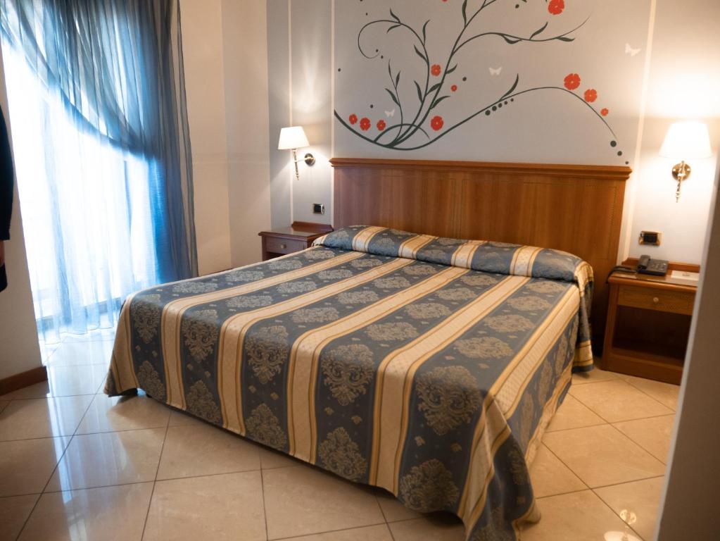 um quarto de hotel com uma cama num quarto em Dipendenza Hotel Londra em Alessandria