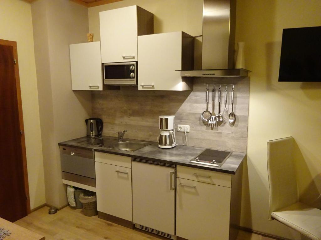 Kuchyň nebo kuchyňský kout v ubytování Apartment zum Wasserfall
