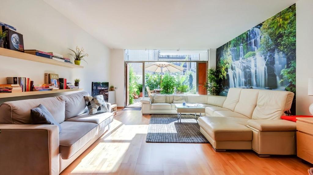 a living room with white furniture and a large window at Modernismo Paseo de Gracia in Barcelona