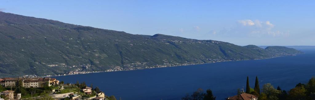 a large body of water next to a mountain at Il Camino in Tignale