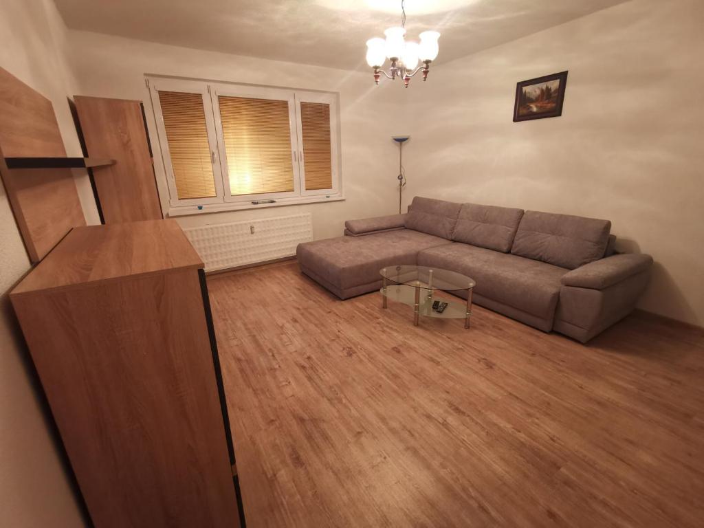 a living room with a couch and a table at Apartman Anro in Kanianka