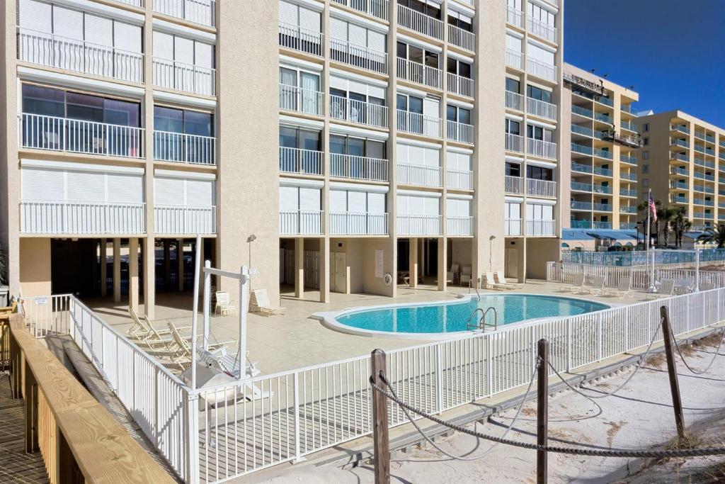 a building with a swimming pool in front of a building at Edgewater West 45 in Gulf Shores