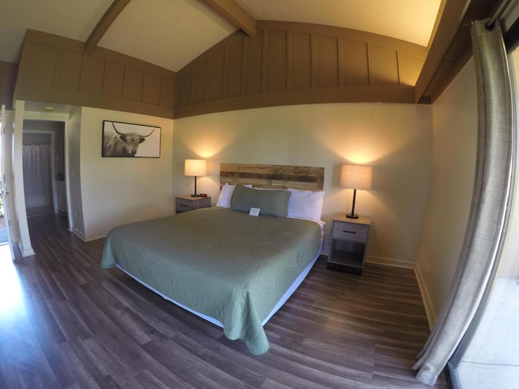 a bedroom with a bed and two lamps in it at Ridgemark Golf Club and Resort in Hollister