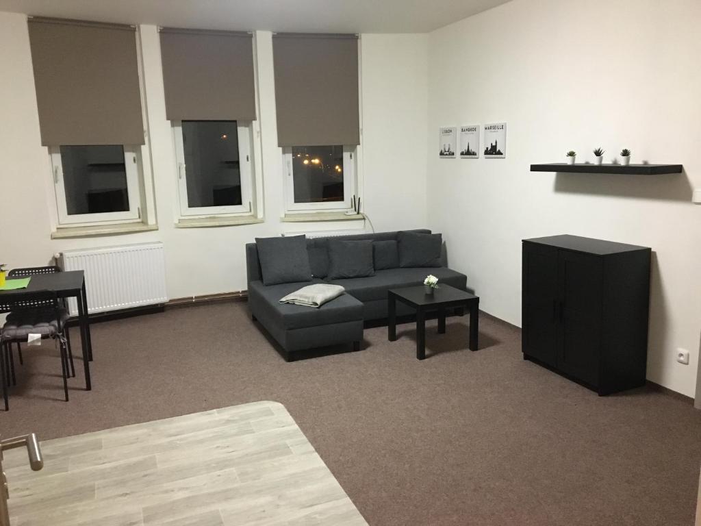 a living room with a couch and a table at Apartmány U Muzea in Děčín