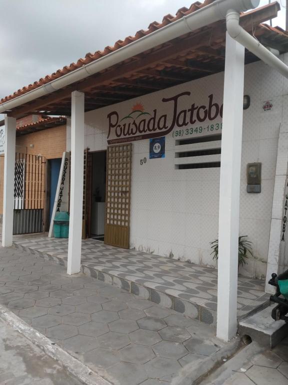 a building with a sign on the side of it at Pousada Jatobá in Barreirinhas