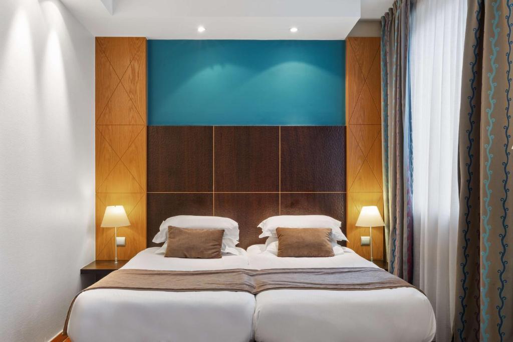 En eller flere senge i et værelse på Best Western Plus Monopole Métropole