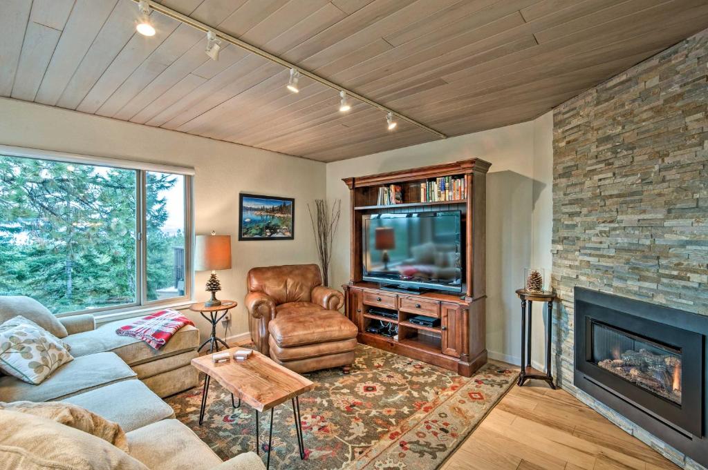 a living room with a couch and a tv and a fireplace at 2 Mi to Heavenly Mountain Tahoe Retreat with Views in Stateline