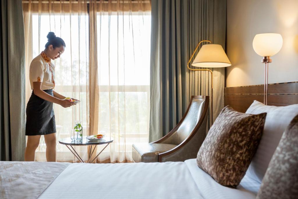 Postel nebo postele na pokoji v ubytování YU Hotel Candolim