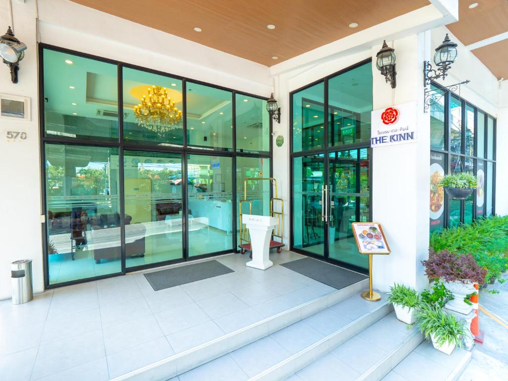 a store front with large windows and a sign in front at The Kinn Bangkok in Bangkok