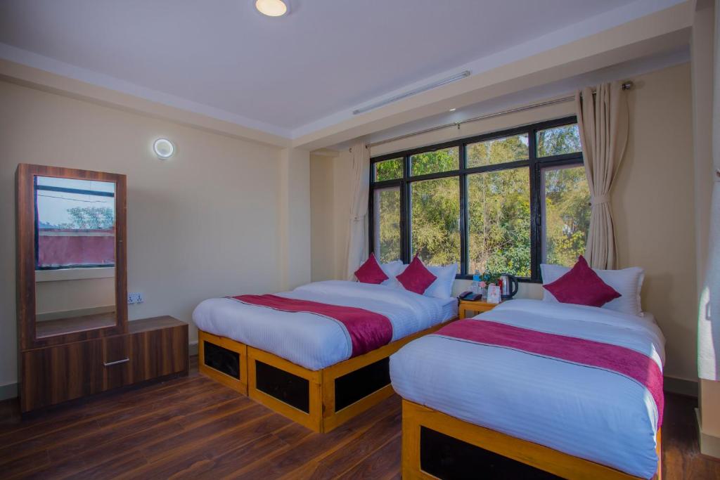 Postel nebo postele na pokoji v ubytování Asha Lodges