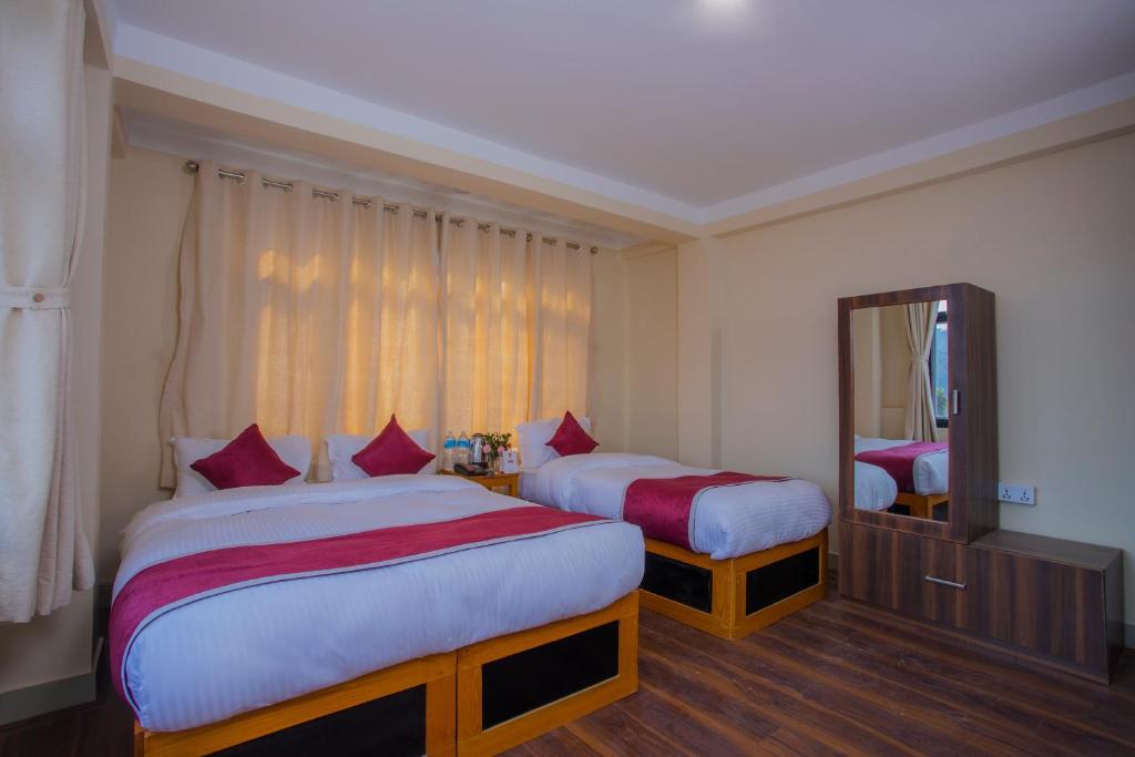 Postel nebo postele na pokoji v ubytování Asha Lodges