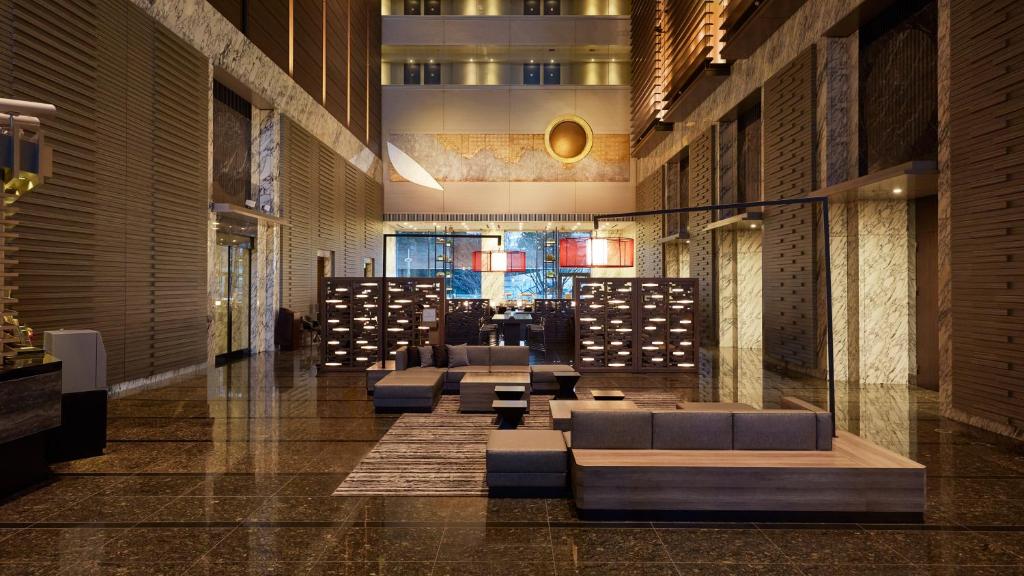 a lobby with couches and tables in a building at Hotel Villa Fontaine Grand Tokyo-Shiodome in Tokyo