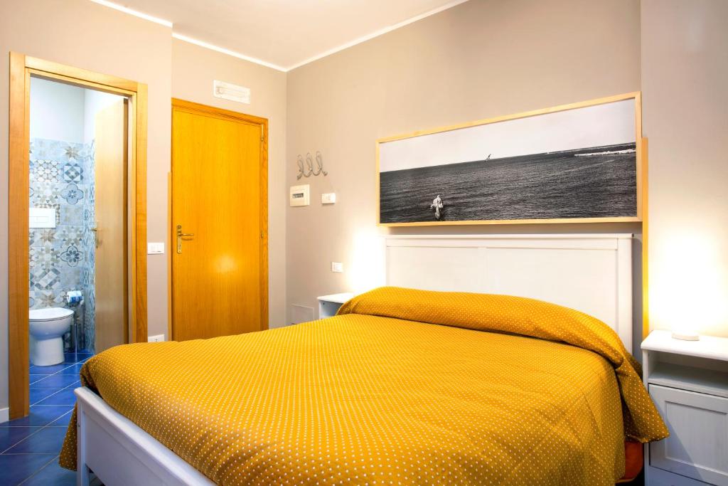 A bed or beds in a room at TerraSole Bakery B&B