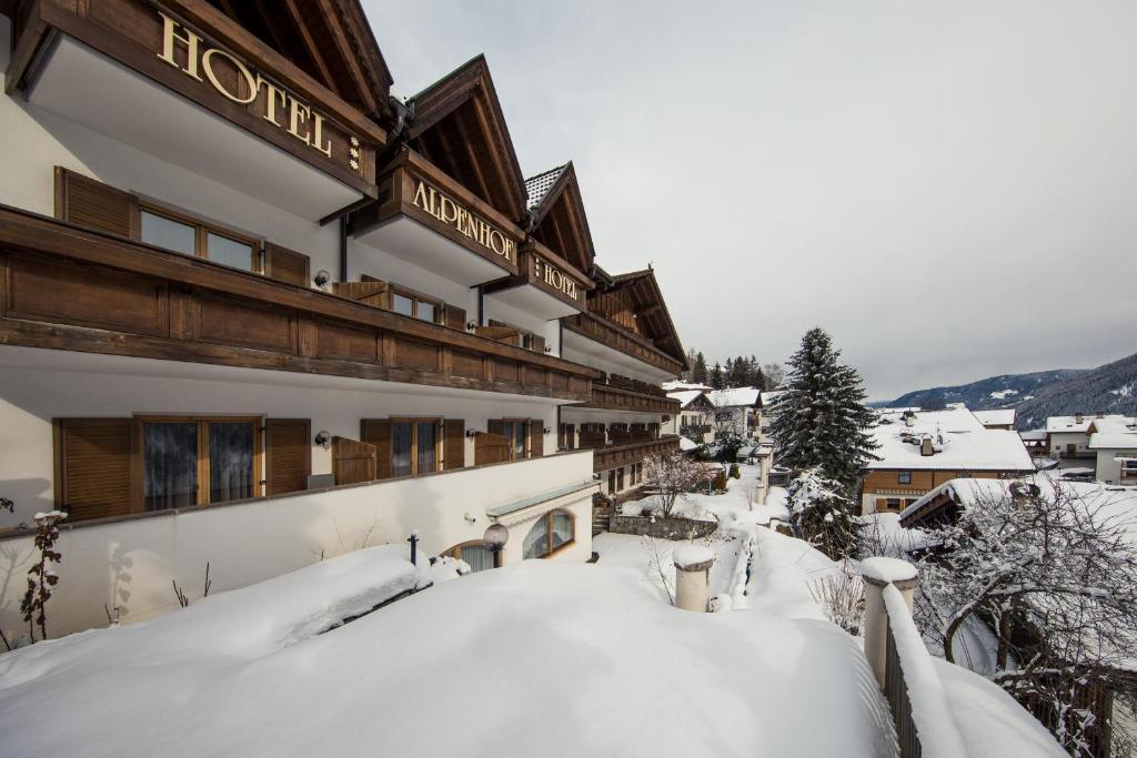 a building in the snow with snow on the ground at Hotel Alpenhof in Ultimo
