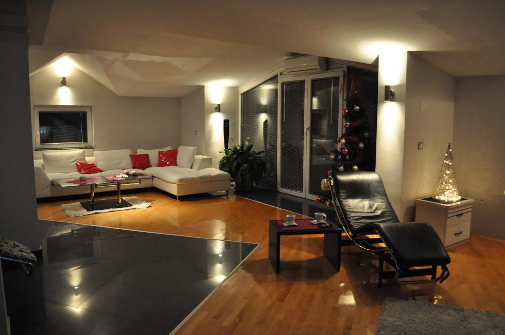 a living room with a christmas tree and a couch at Comfort Deluxe Kosmos Apartments in Ohrid