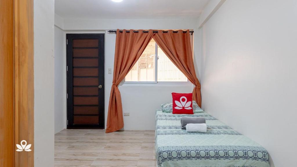 Postel nebo postele na pokoji v ubytování Happy Grey Hotel Vigan