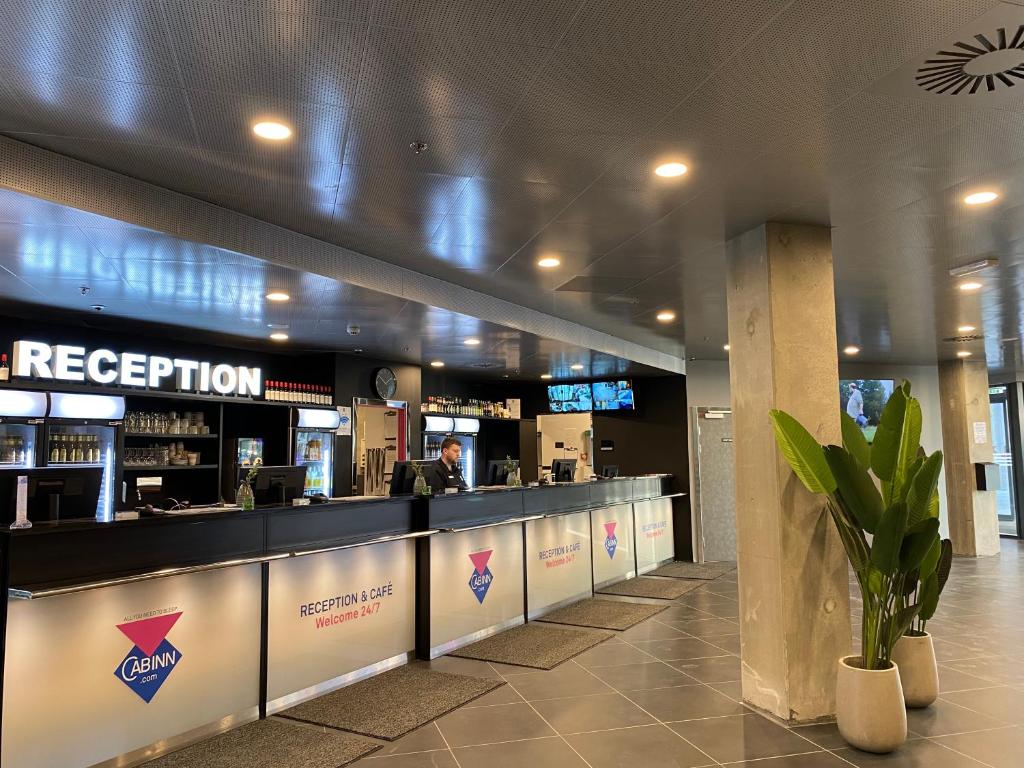 a restaurant with a reception counter in a building at Cabinn Copenhagen in Copenhagen
