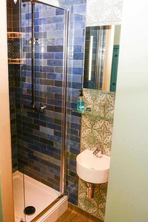 a bathroom with a sink and a shower and a toilet at Plough Inn in Morpeth