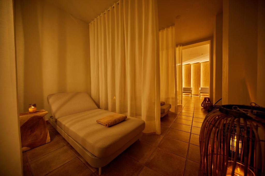 a small bedroom with a bed and a window at Secrets Lanzarote Resort & Spa - Adults Only (+18) in Puerto Calero