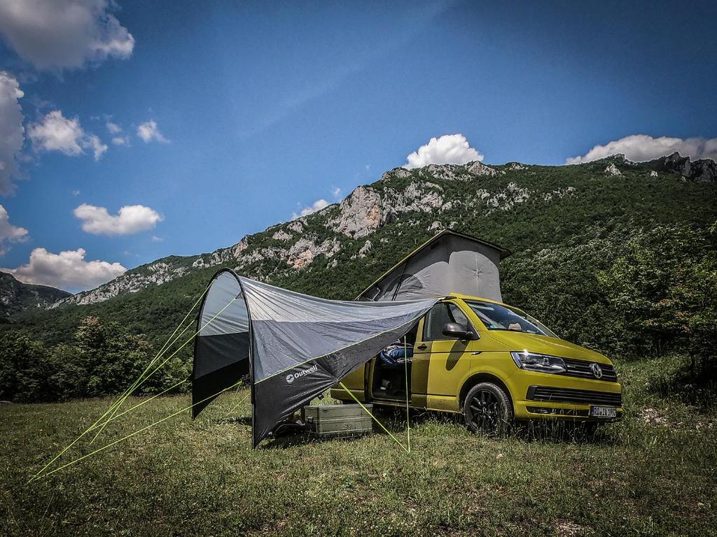 a yellow van parked in a field with a tent at GRAB ethno village and camp in Šćepan-Polje