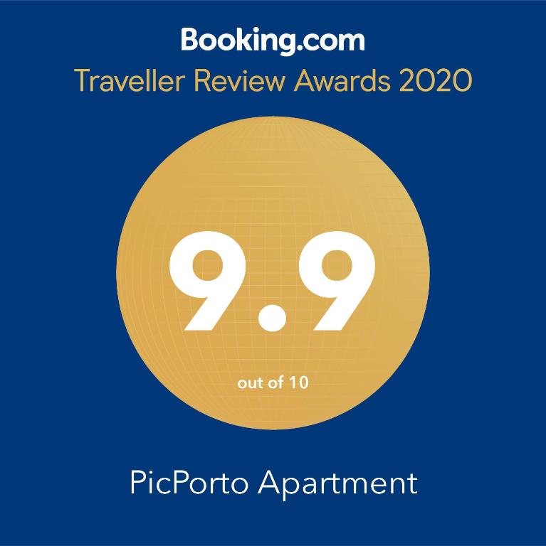 a sign that reads traveler review awards with a yellow circle at PicPorto Apartment in Porto